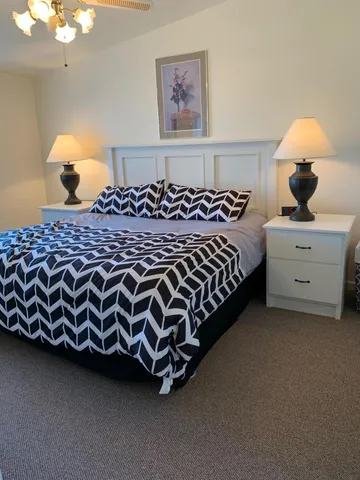 a bed room with a bed and a chandelier