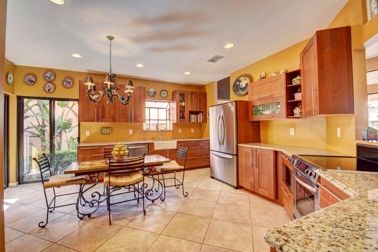 6528 Via Rosa Boca Raton, FL 33433 - Photo 6 of 22 a open kitchen with stainless steel appliances granite countertop a sink and a refrigerator
