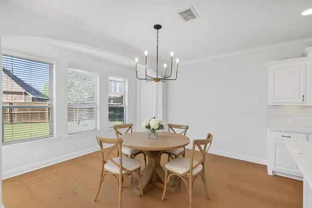 a view of kitchen with sink and refrigerator