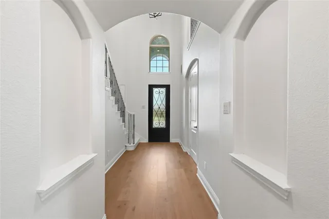 a view of staircase with railing and white walls
