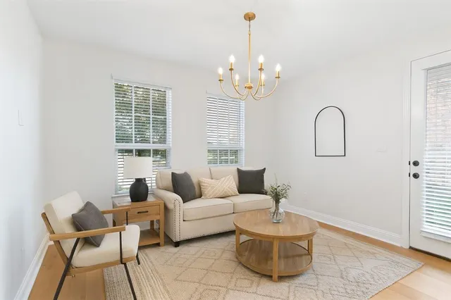 a living room with furniture and a chandelier
