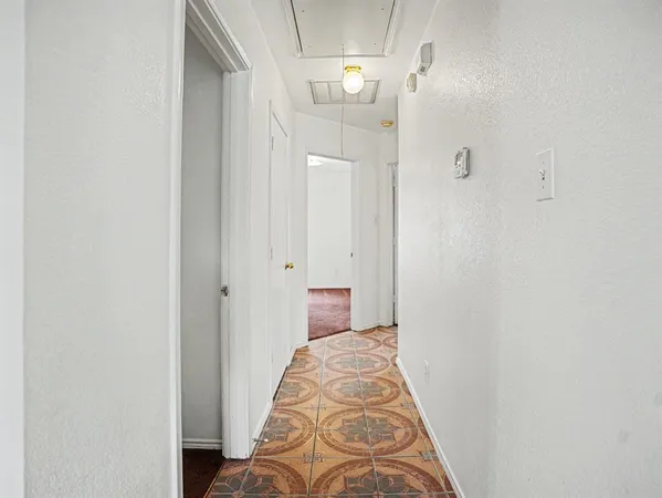 a view of a bedroom with wooden floor