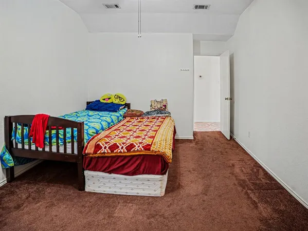 a bedroom with two beds and dresser