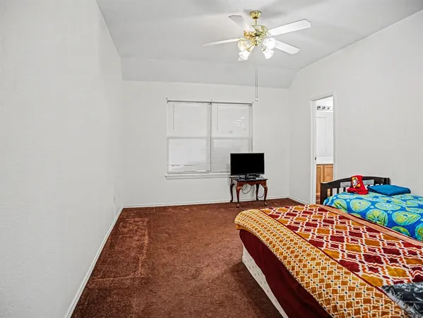a bedroom with bed and a table