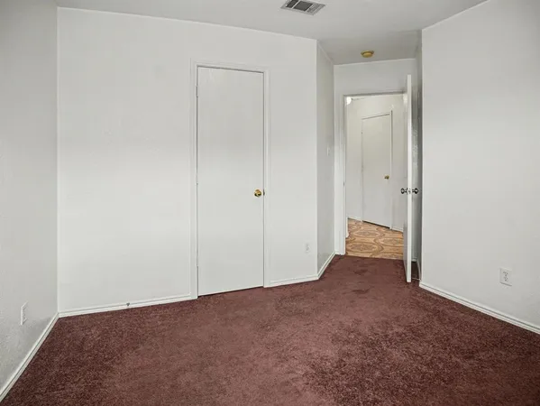 an empty room with closet area