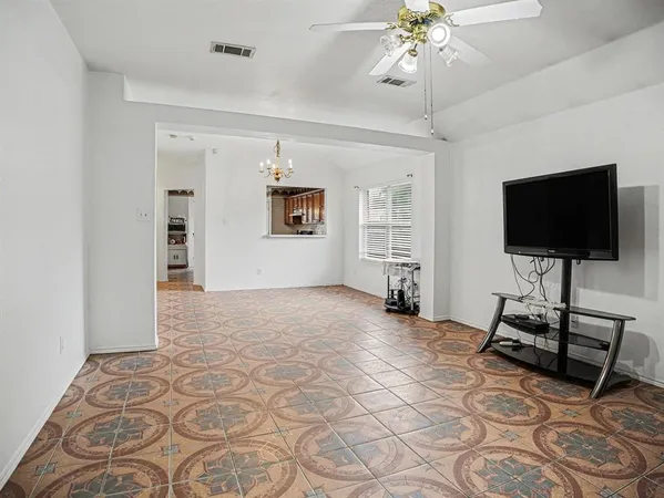 a view of a livingroom with wooden floor and a flat screen tv