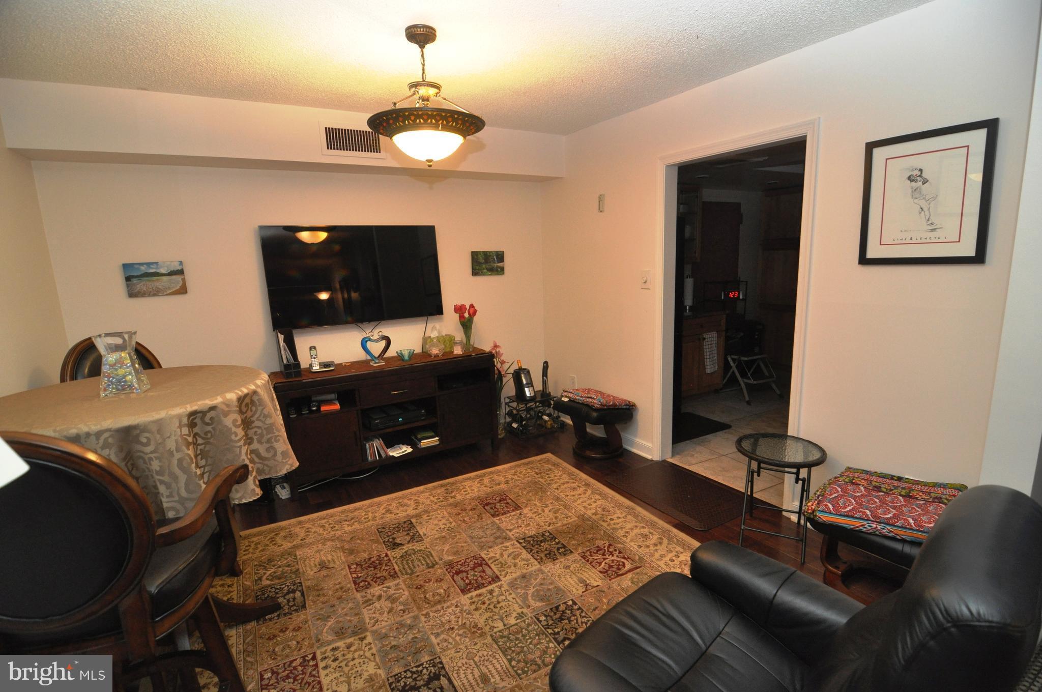 1101 South Arlington Ridge Road, Unit 204 Arlington, VA 22202 - Photo 11 of 28 a living room with furniture and a flat screen tv