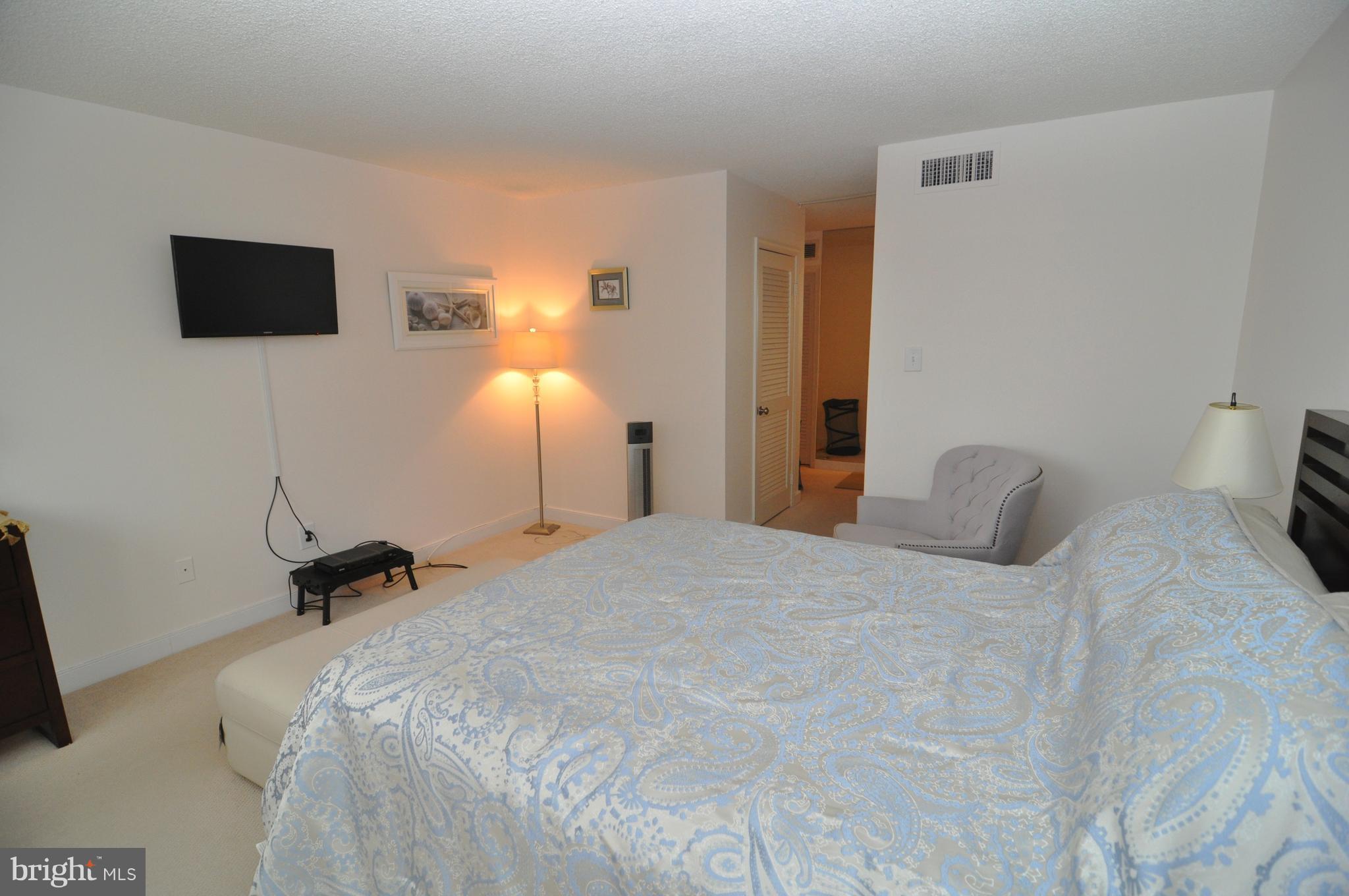 1101 South Arlington Ridge Road, Unit 204 Arlington, VA 22202 - Photo 15 of 28 a bedroom with a bed and a flat screen tv