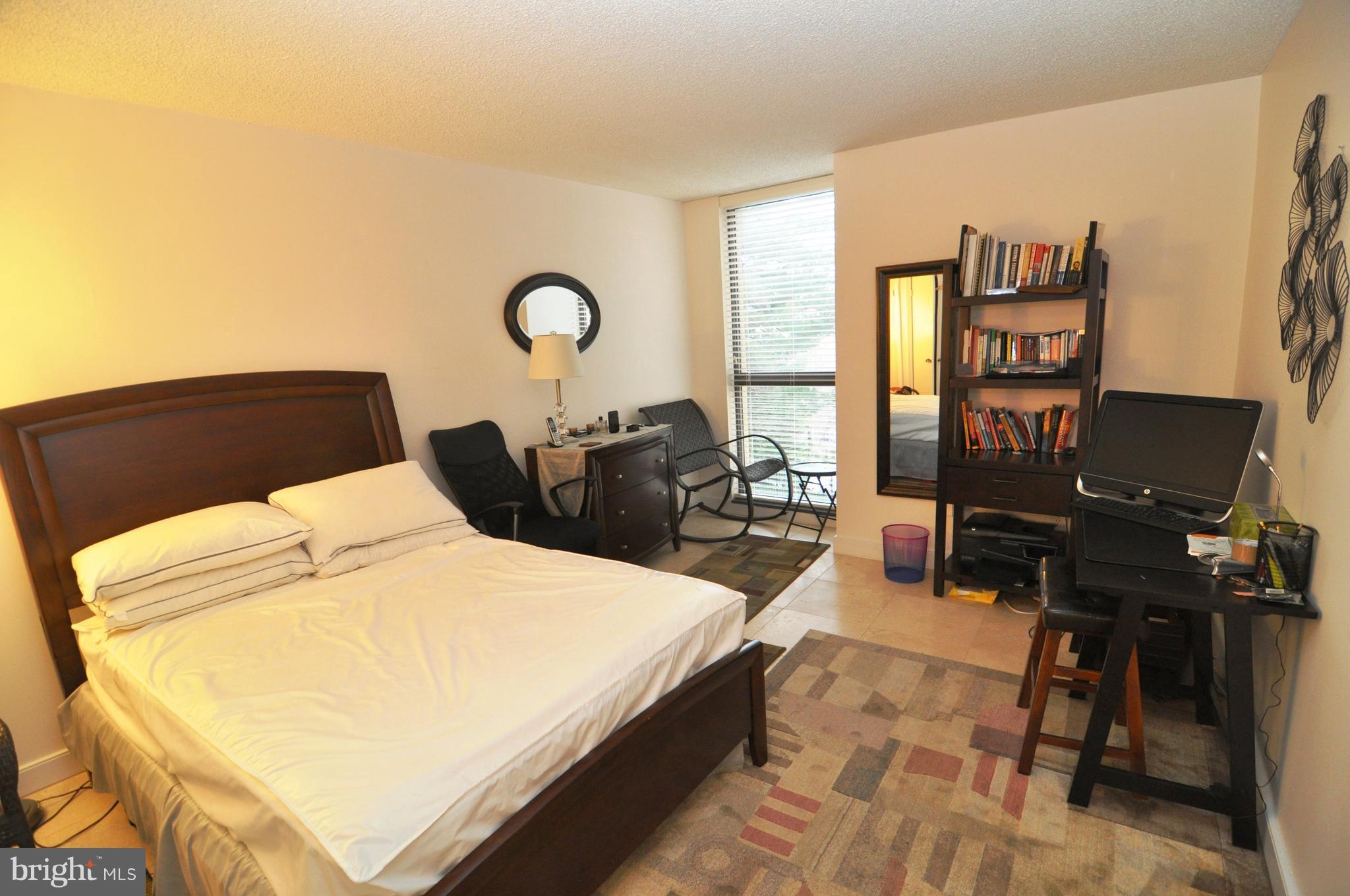 1101 South Arlington Ridge Road, Unit 204 Arlington, VA 22202 - Photo 18 of 28 a bedroom with a bed and wooden floor
