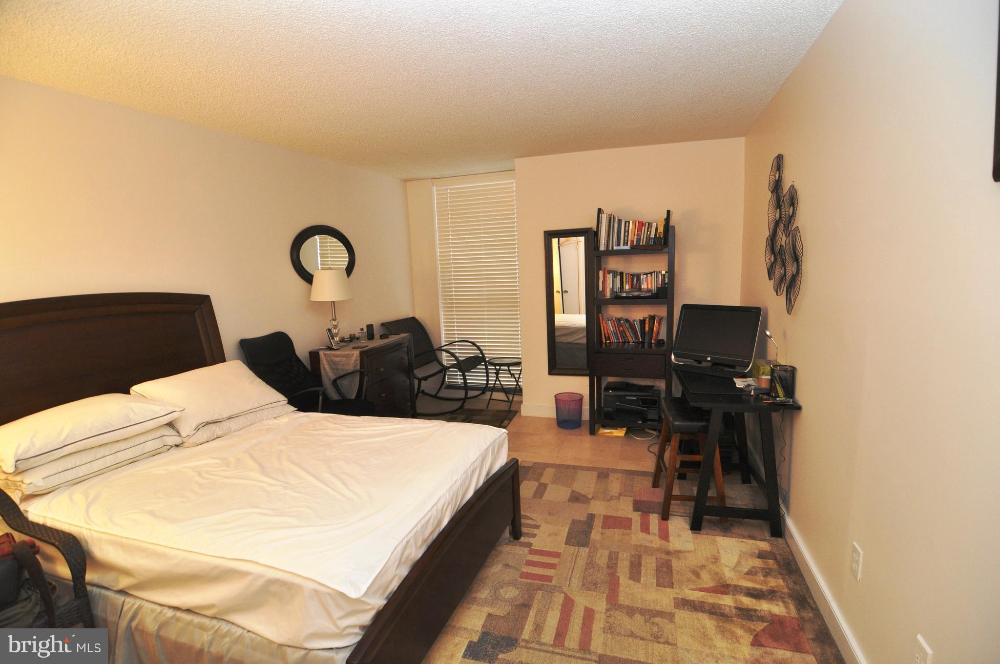 1101 South Arlington Ridge Road, Unit 204 Arlington, VA 22202 - Photo 19 of 28 a bed room with a bed and a television