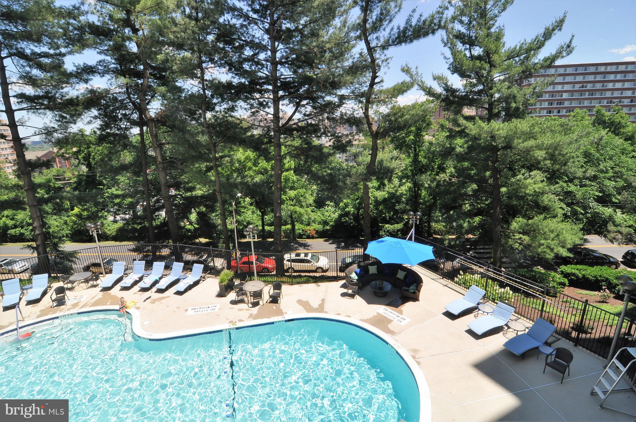 1101 South Arlington Ridge Road, Unit 204 Arlington, VA 22202 - Photo 23 of 28 a view of a swimming pool with chairs
