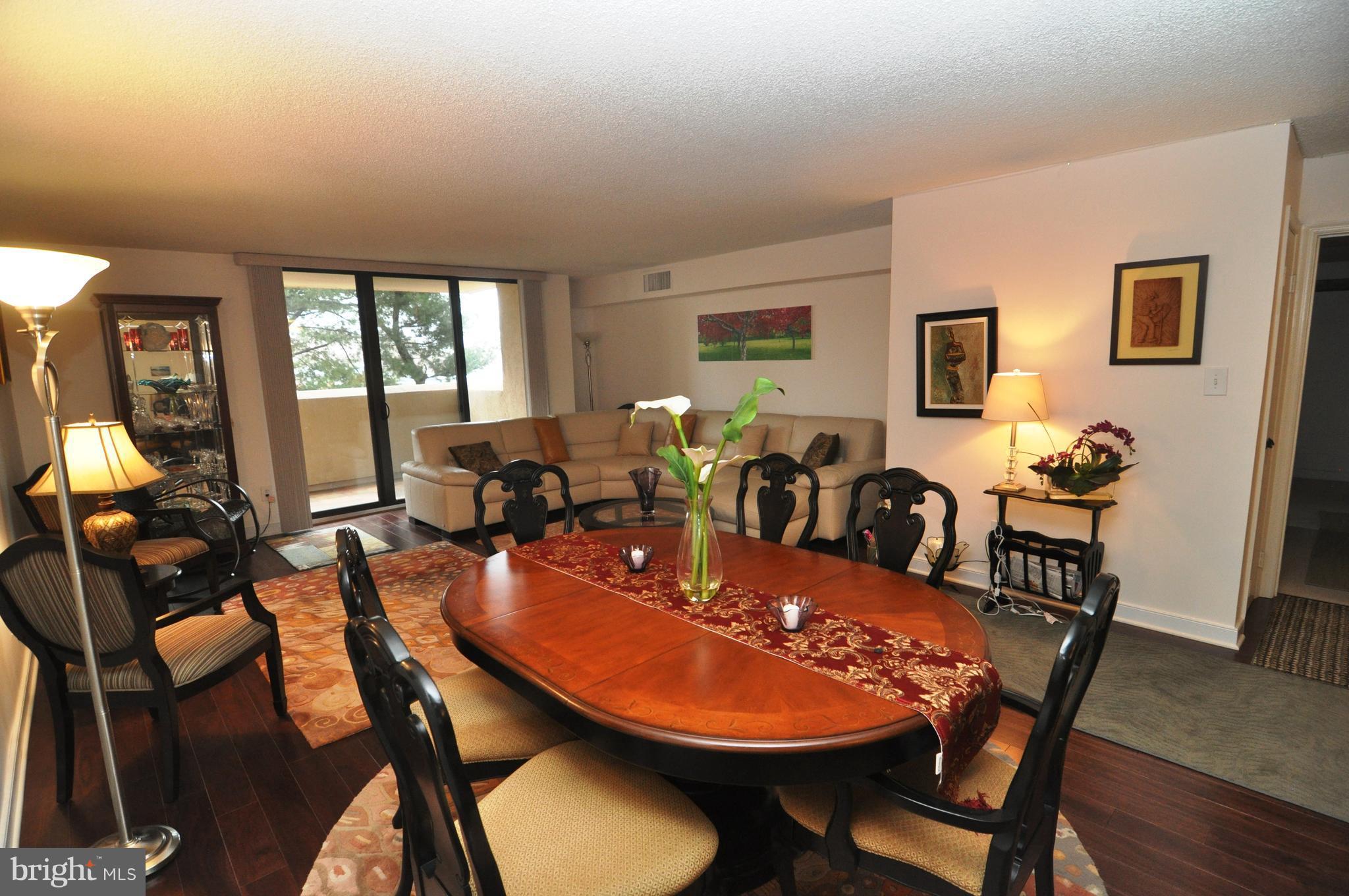 1101 South Arlington Ridge Road, Unit 204 Arlington, VA 22202 - Photo 6 of 28 a dining room with furniture a window and wooden floor