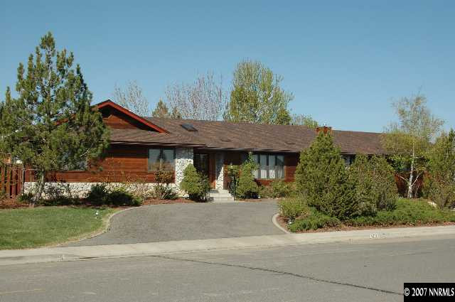 4287 Muirwood Court Reno, NV 89509 - Photo 1 of 7 a front view of a house with a yard and garage