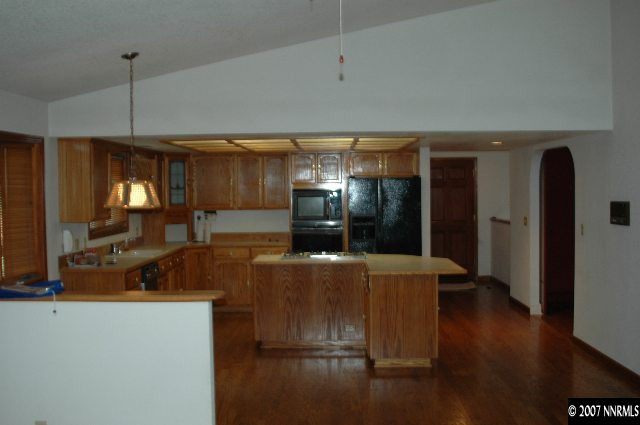 4287 Muirwood Court Reno, NV 89509 - Photo 5 of 7 a kitchen with stainless steel appliances wooden floor and chair