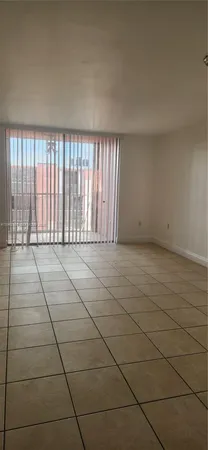 a view of an empty room and a window