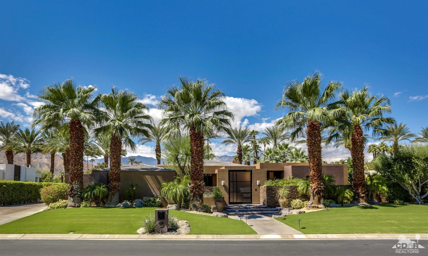 37 Sun Ridge Circle Rancho Mirage, CA 92270 - Photo 3 of 63 a front view of a house with a yard and palm trees