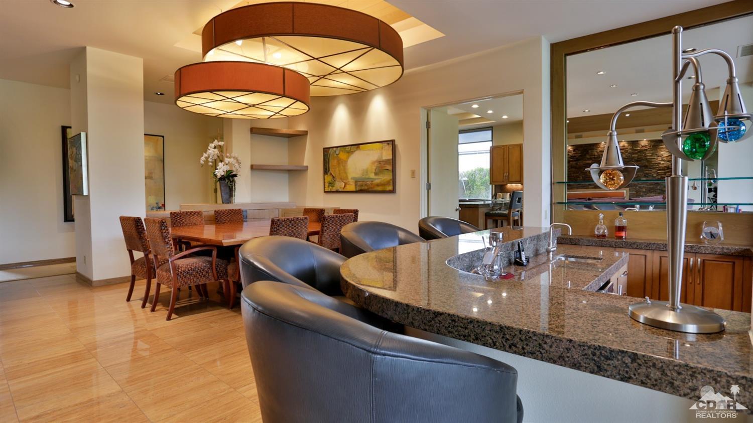 37 Sun Ridge Circle Rancho Mirage, CA 92270 - Photo 23 of 63 a dining hall with couches a flat tv screen and couches with wooden floor