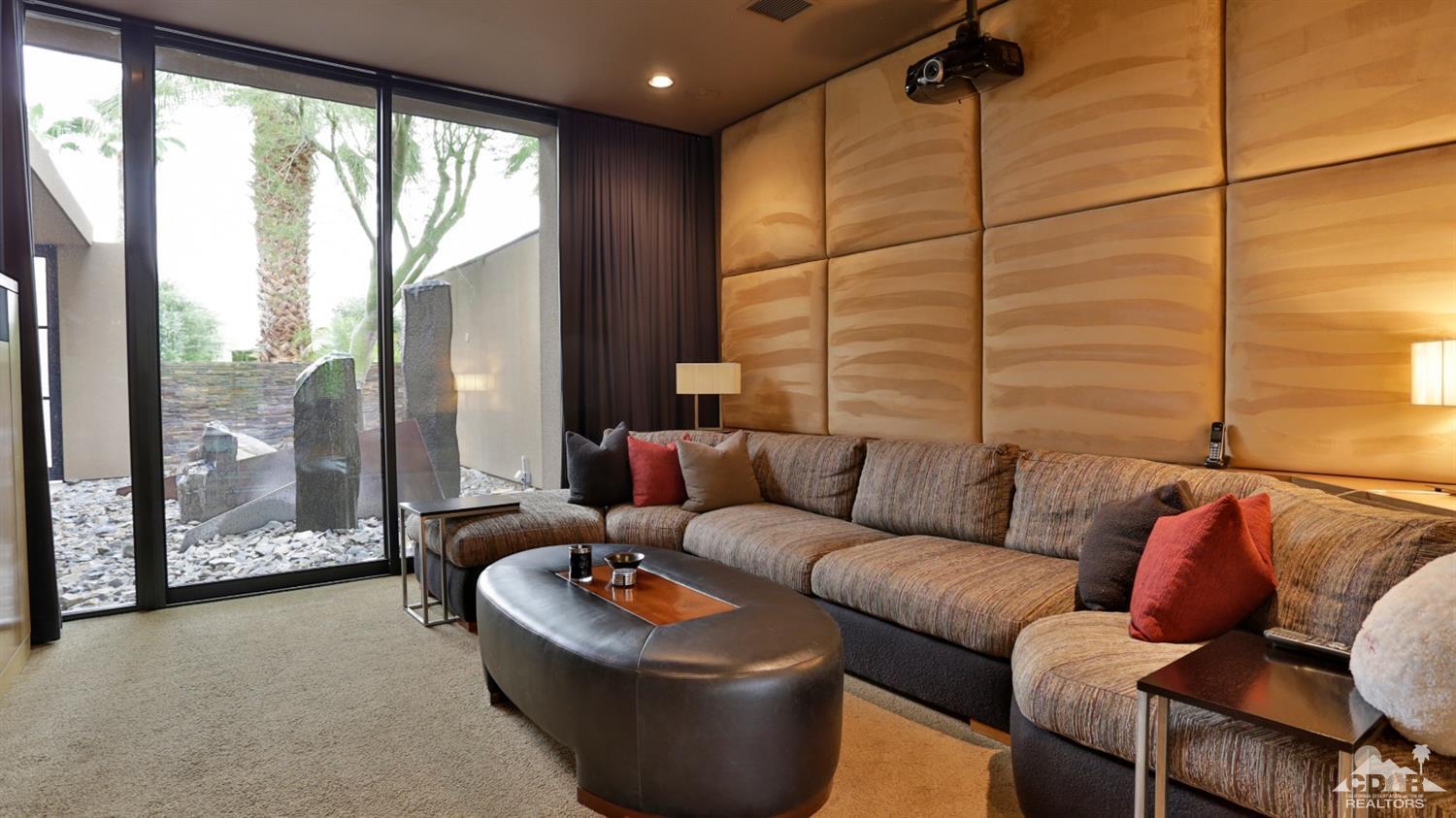 37 Sun Ridge Circle Rancho Mirage, CA 92270 - Photo 24 of 63 a living room with furniture and a floor to ceiling window