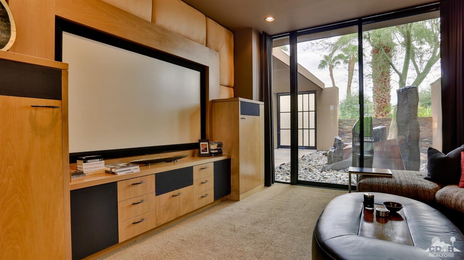 37 Sun Ridge Circle Rancho Mirage, CA 92270 - Photo 27 of 63 a living room with furniture flat screen tv and a large window