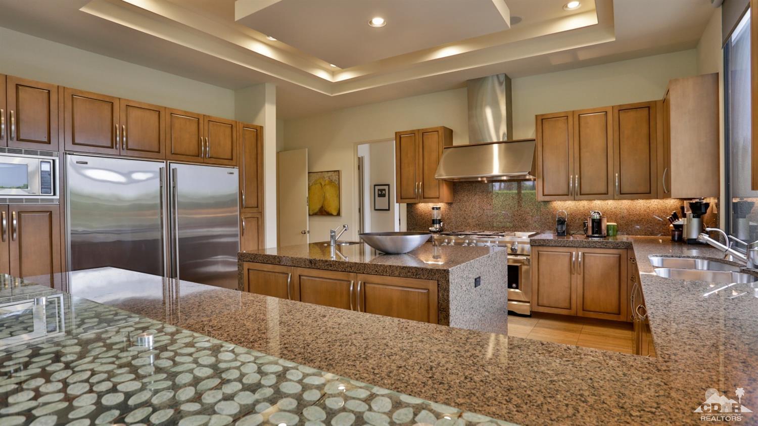 37 Sun Ridge Circle Rancho Mirage, CA 92270 - Photo 29 of 63 a kitchen with stainless steel appliances granite countertop a refrigerator a stove and a sink