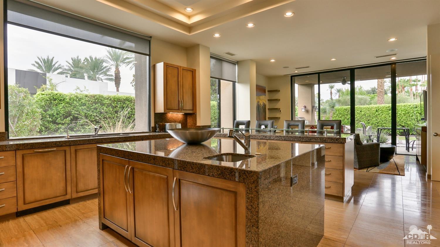 37 Sun Ridge Circle Rancho Mirage, CA 92270 - Photo 34 of 63 a dining hall with stainless steel appliances granite countertop a sink a stove and a wooden floors