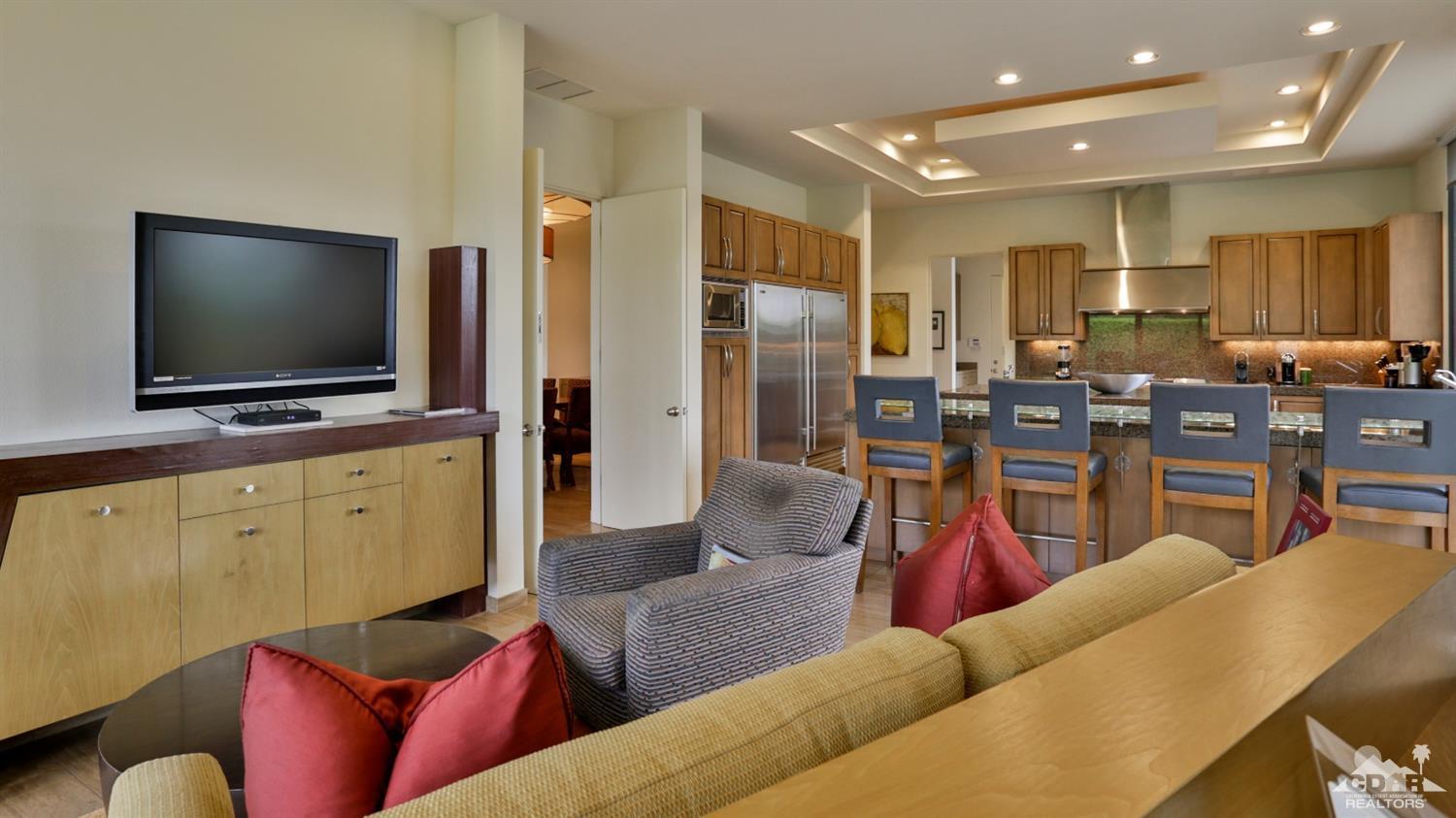 37 Sun Ridge Circle Rancho Mirage, CA 92270 - Photo 37 of 63 a living room with furniture kitchen view and a flat screen tv