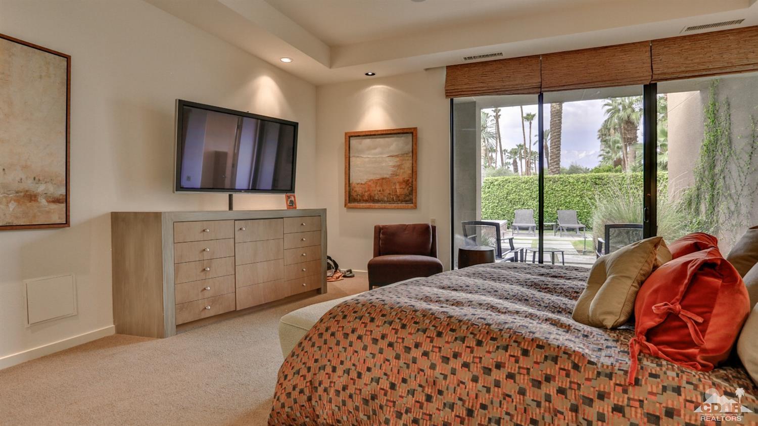 37 Sun Ridge Circle Rancho Mirage, CA 92270 - Photo 43 of 63 a bedroom with a large bed and a flat tv screen on dresser