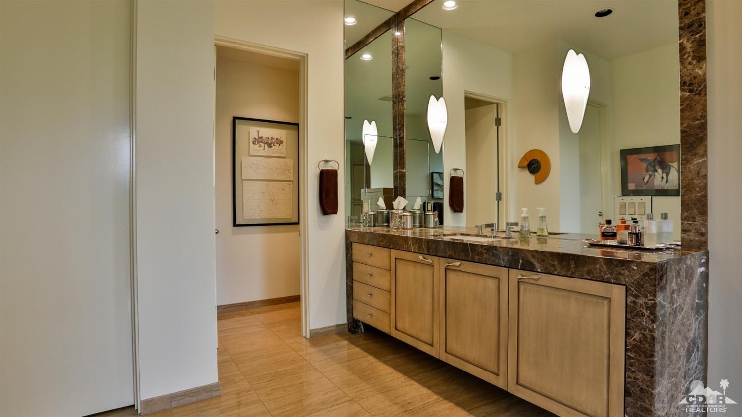 37 Sun Ridge Circle Rancho Mirage, CA 92270 - Photo 44 of 63 a bathroom with a granite countertop sink and a mirror