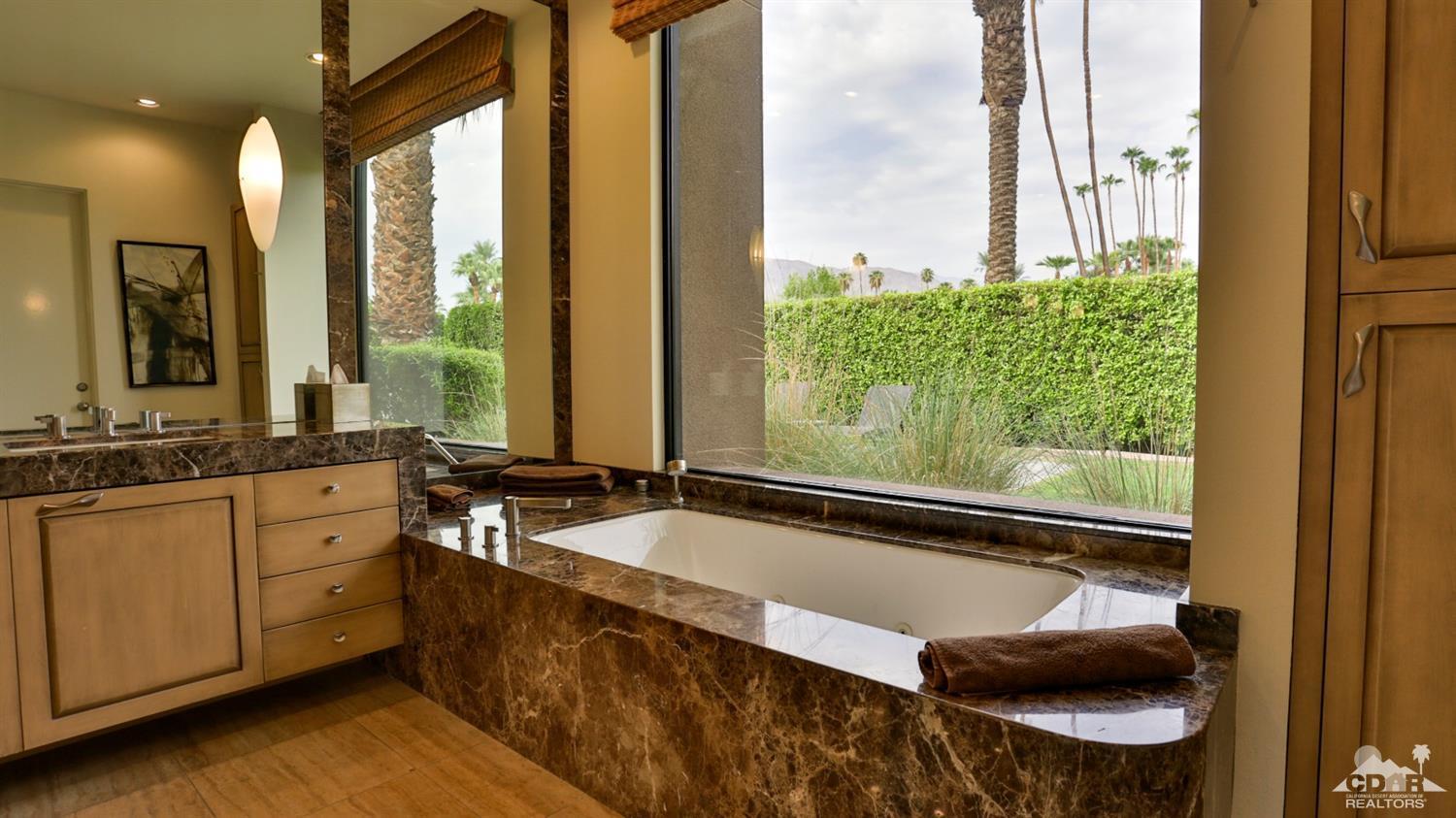 37 Sun Ridge Circle Rancho Mirage, CA 92270 - Photo 46 of 63 a bathroom with a granite countertop tub and a sink