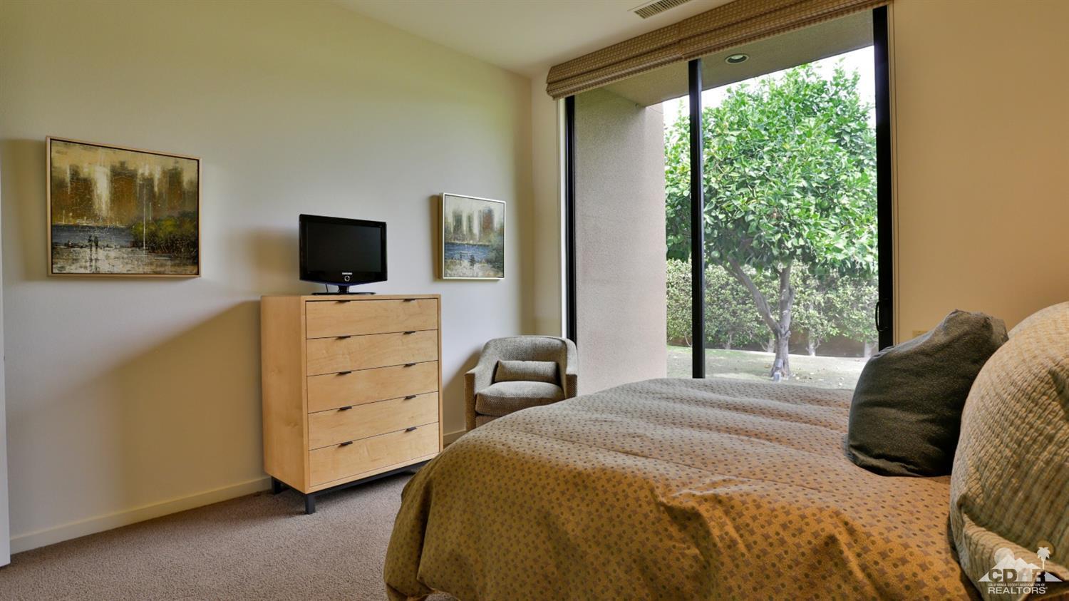 37 Sun Ridge Circle Rancho Mirage, CA 92270 - Photo 51 of 63 a bedroom with a bed and a flat tv screen on dresser
