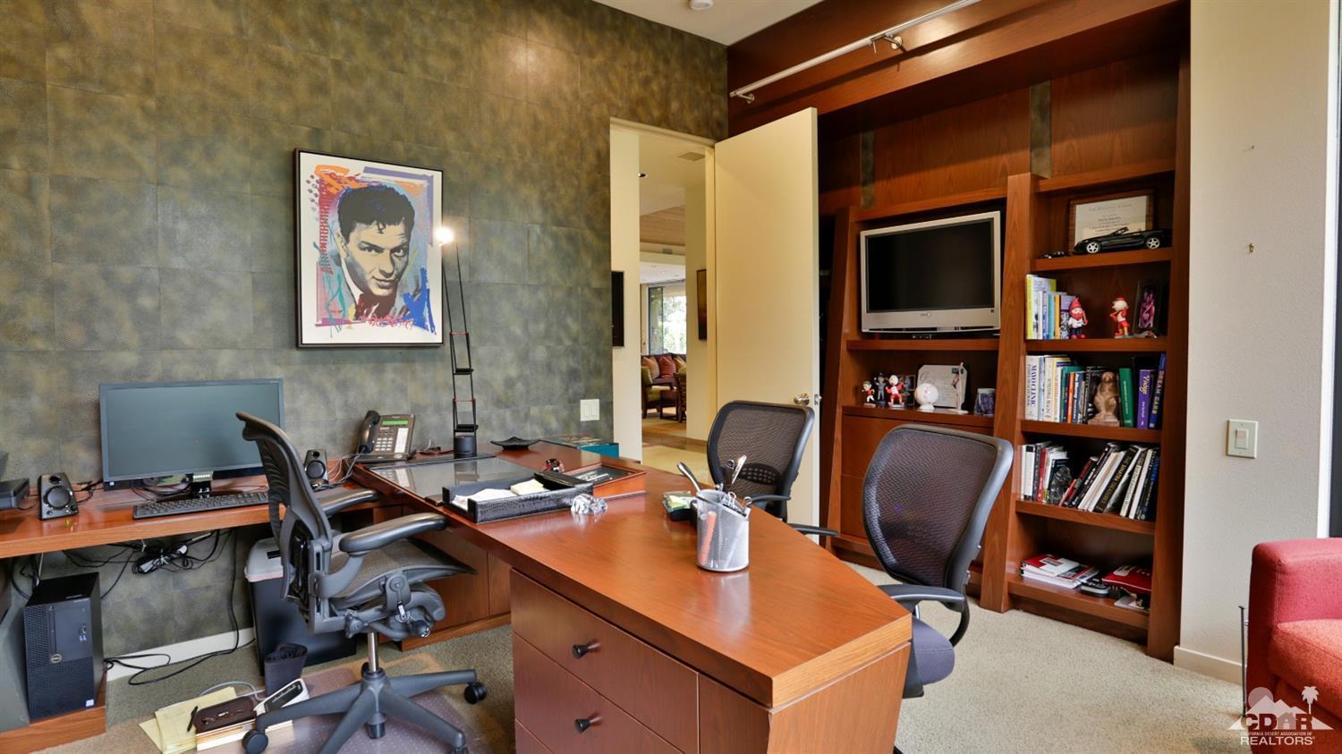 37 Sun Ridge Circle Rancho Mirage, CA 92270 - Photo 56 of 63 a view of a workspace with furniture and a bookshelf