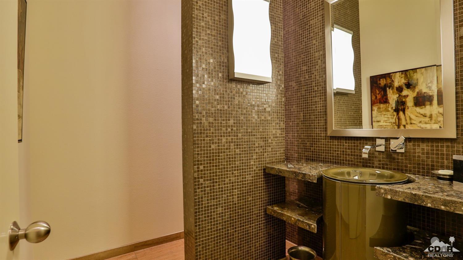 37 Sun Ridge Circle Rancho Mirage, CA 92270 - Photo 57 of 63 a bathroom with a sink and a mirror