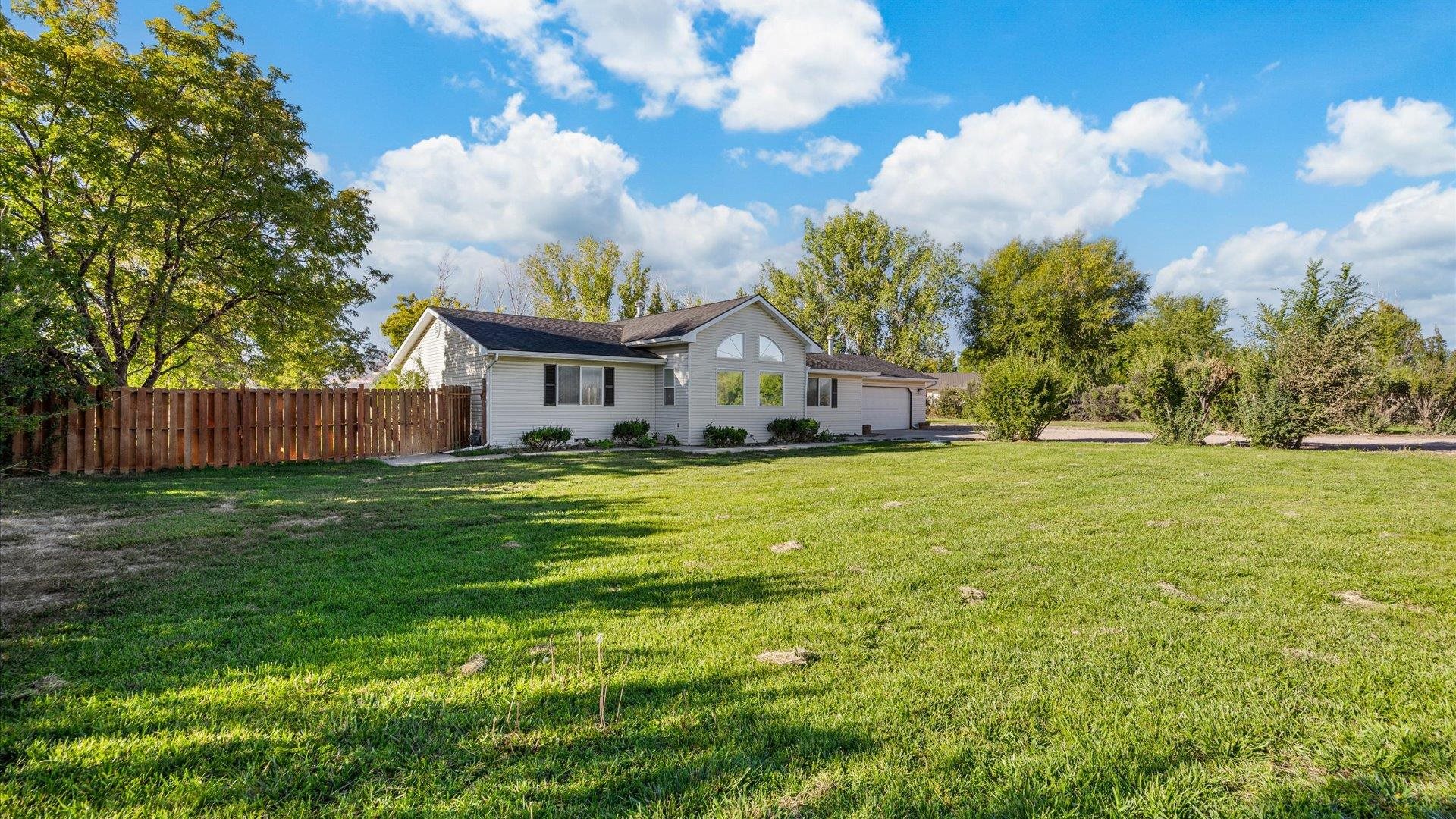 a front view of house with yard and green space