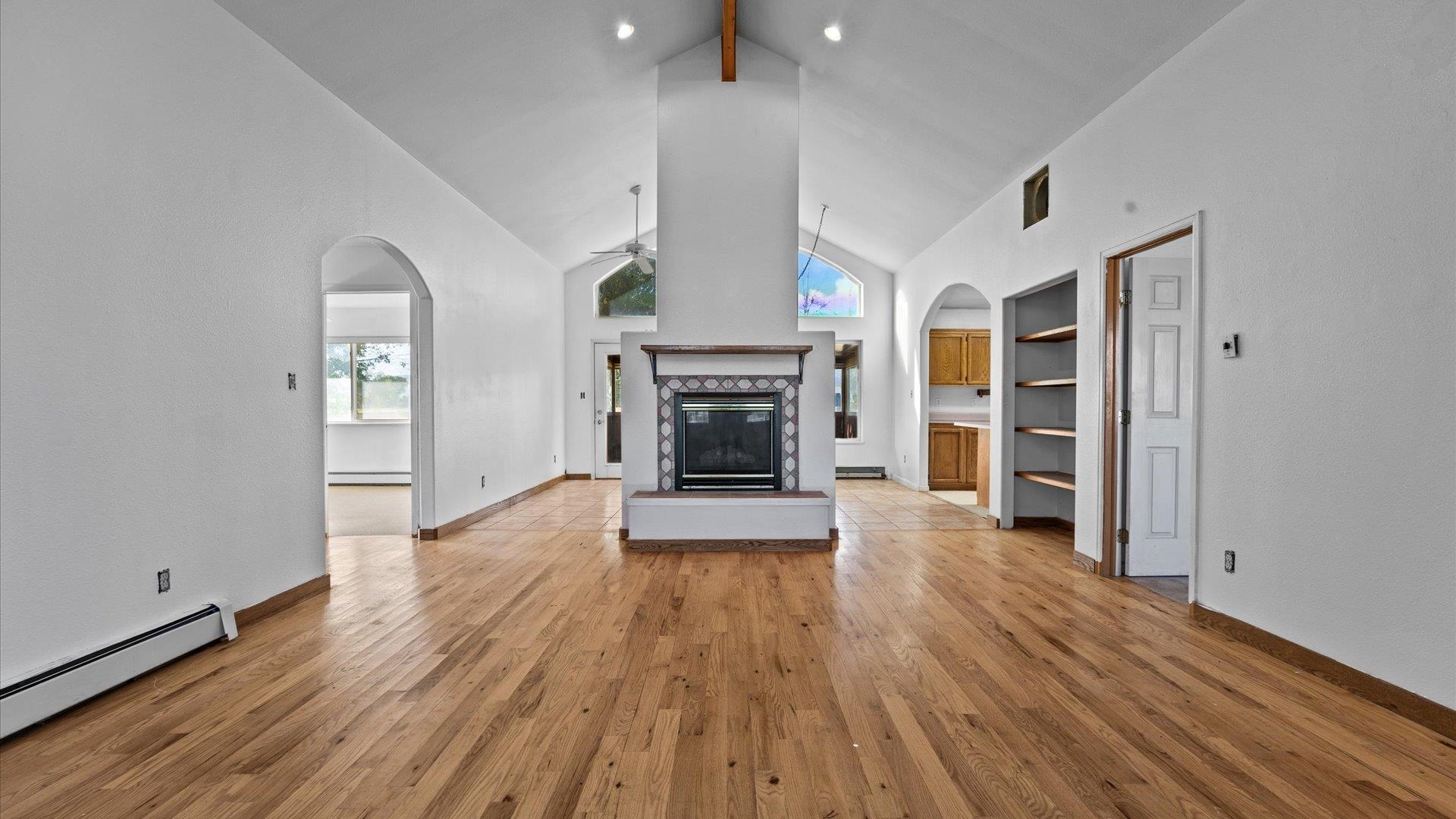1351 M M 1/4 Road Loma, CO 81524 - Photo 14 of 36 an empty room with wooden floor fireplace and windows