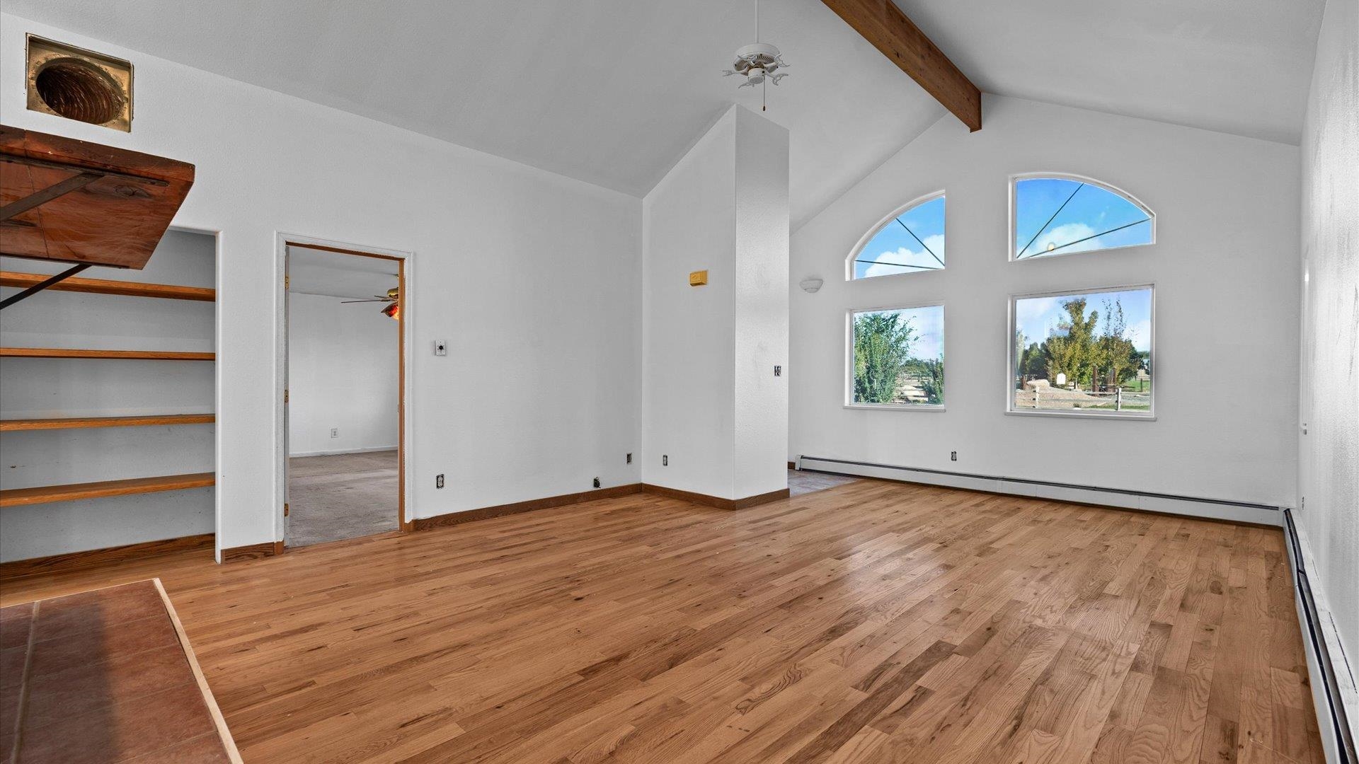 1351 M M 1/4 Road Loma, CO 81524 - Photo 16 of 36 a view of an empty room with a window and wooden floor