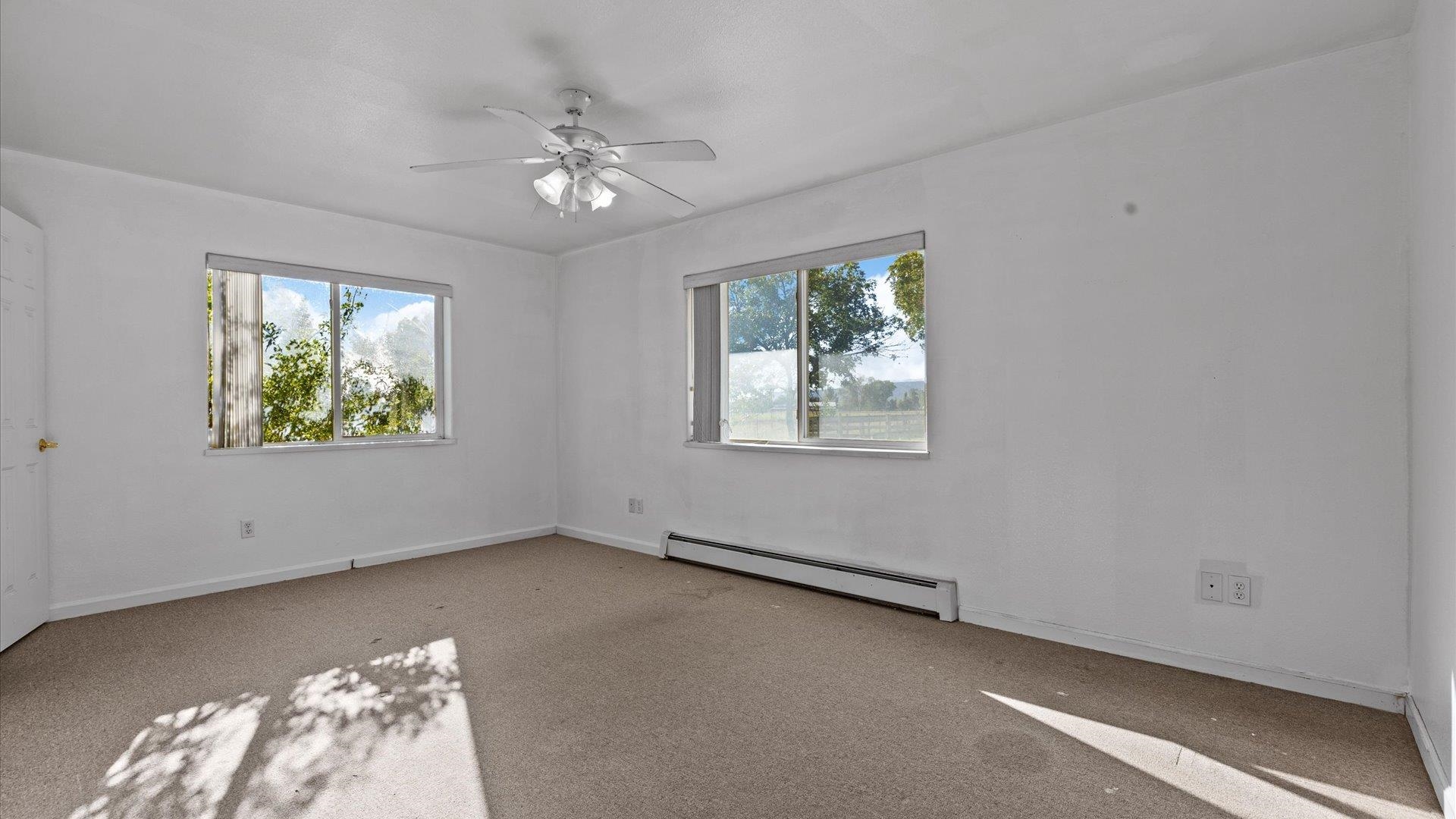 1351 M M 1/4 Road Loma, CO 81524 - Photo 19 of 36 wooden floor in an empty room with a window