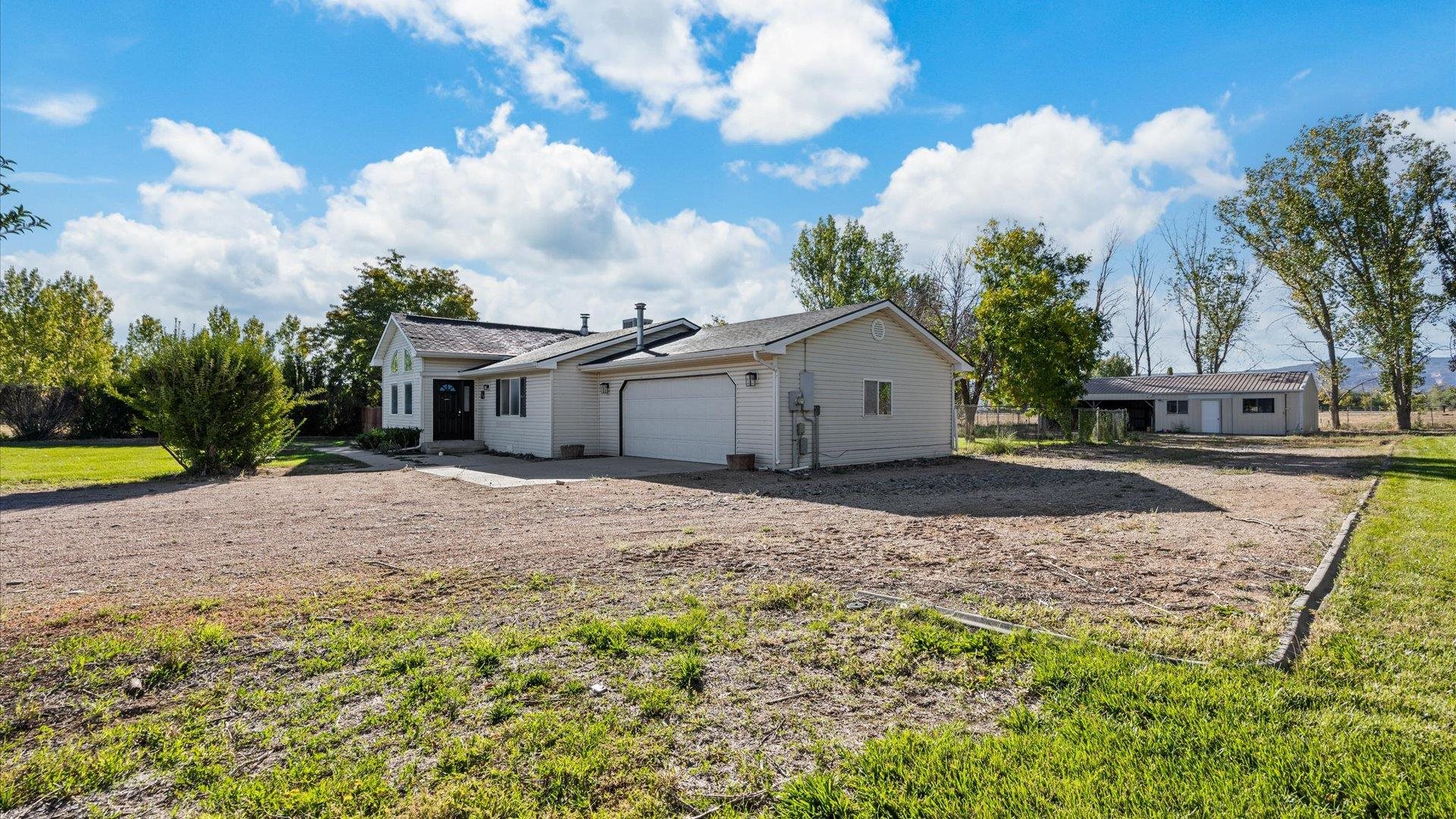 1351 M M 1/4 Road Loma, CO 81524 - Photo 3 of 36 a view of a house with backyard and sitting area