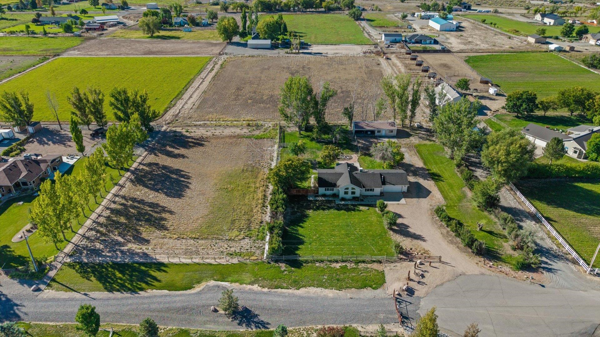 1351 M M 1/4 Road Loma, CO 81524 - Photo 33 of 36 an aerial view of a house with a garden