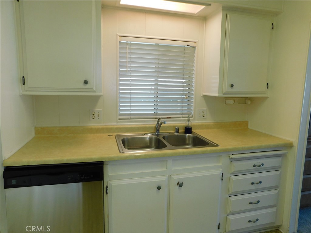 10675 Bryant Street, Unit 112 Yucaipa, CA 92399 - Photo 22 of 49 a kitchen with a sink and cabinets