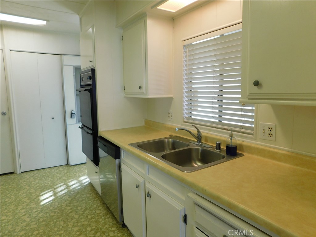 10675 Bryant Street, Unit 112 Yucaipa, CA 92399 - Photo 25 of 49 a kitchen with a sink and a refrigerator