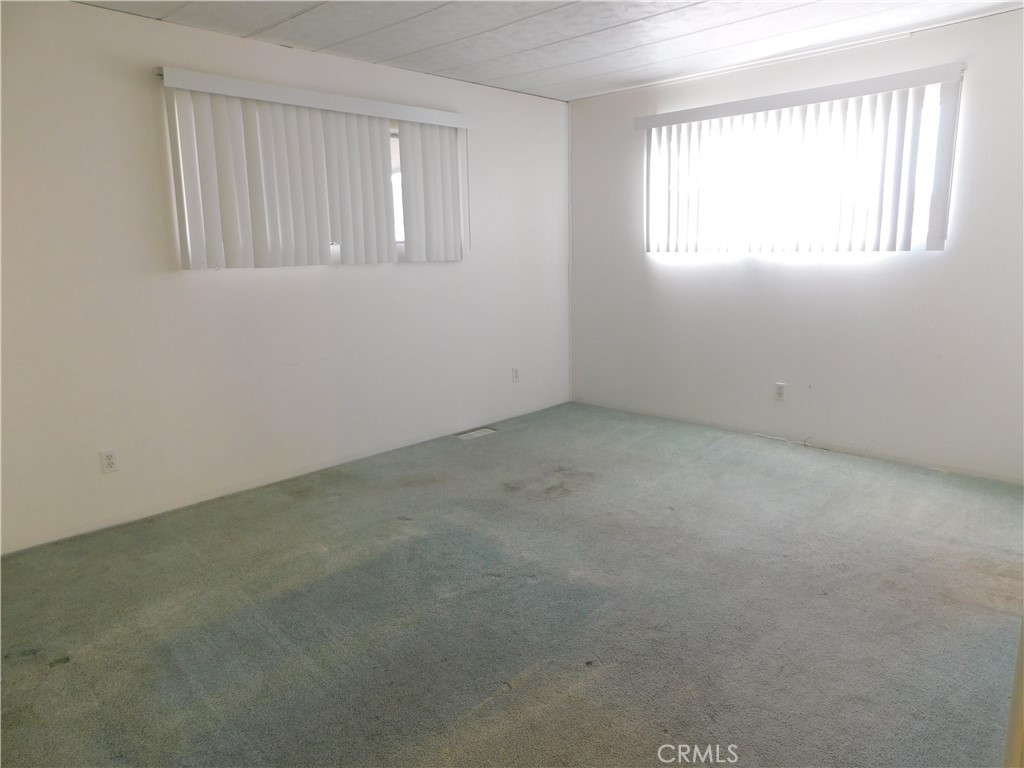 10675 Bryant Street, Unit 112 Yucaipa, CA 92399 - Photo 27 of 49 an empty room with windows
