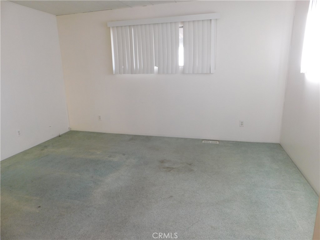 10675 Bryant Street, Unit 112 Yucaipa, CA 92399 - Photo 28 of 49 an empty room with windows