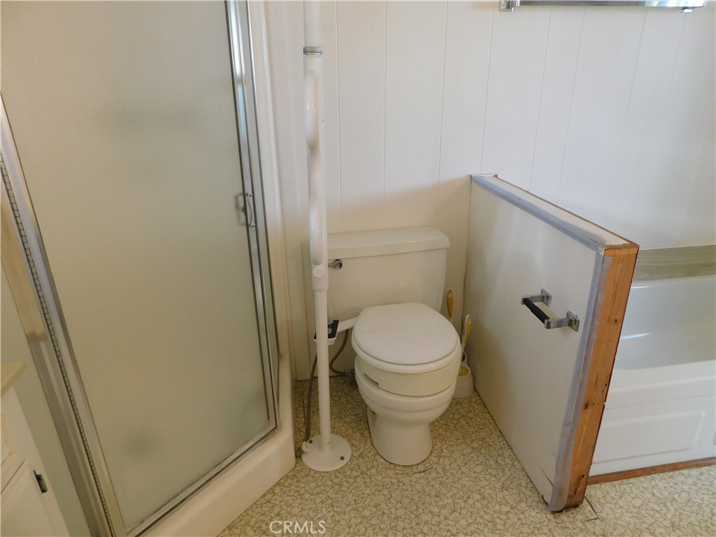 10675 Bryant Street, Unit 112 Yucaipa, CA 92399 - Photo 37 of 49 a bathroom with a toilet and a shower