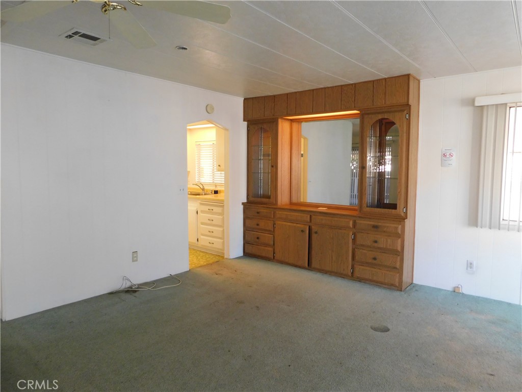 10675 Bryant Street, Unit 112 Yucaipa, CA 92399 - Photo 6 of 49 wooden floor in an empty room and a window