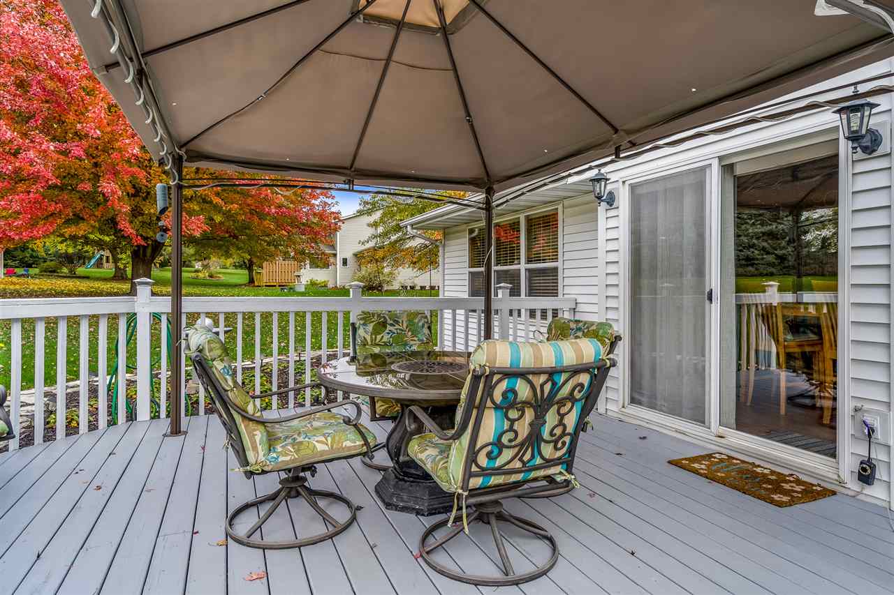 9414 Rambouillet Ridge Roscoe, IL 61073 - Photo 11 of 39 a view of chair and tables in the balcony