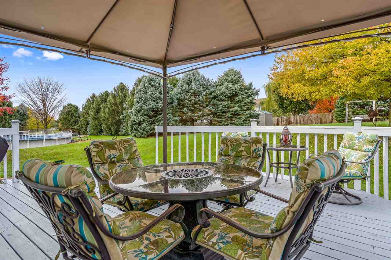 9414 Rambouillet Ridge Roscoe, IL 61073 - Photo 12 of 39 a view of a patio with a table chairs and a table