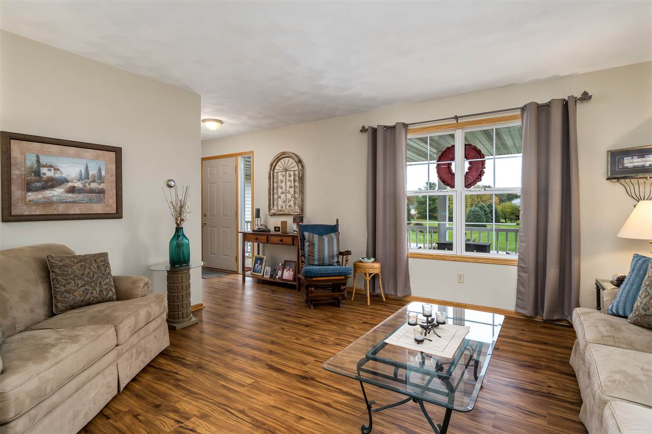 9414 Rambouillet Ridge Roscoe, IL 61073 - Photo 16 of 39 a living room with furniture and a large window