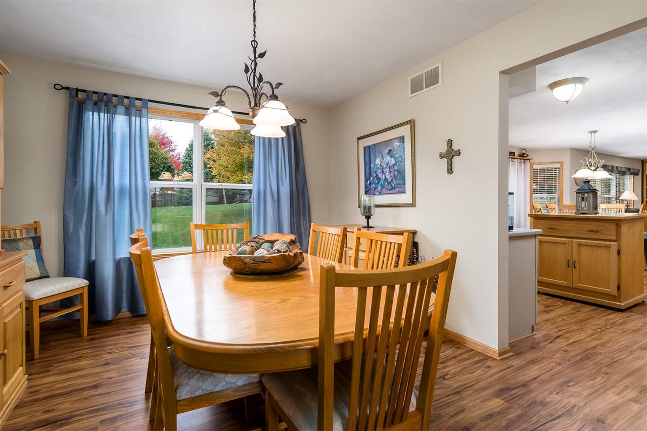 9414 Rambouillet Ridge Roscoe, IL 61073 - Photo 17 of 39 a view of a dining room with furniture window and wooden floor