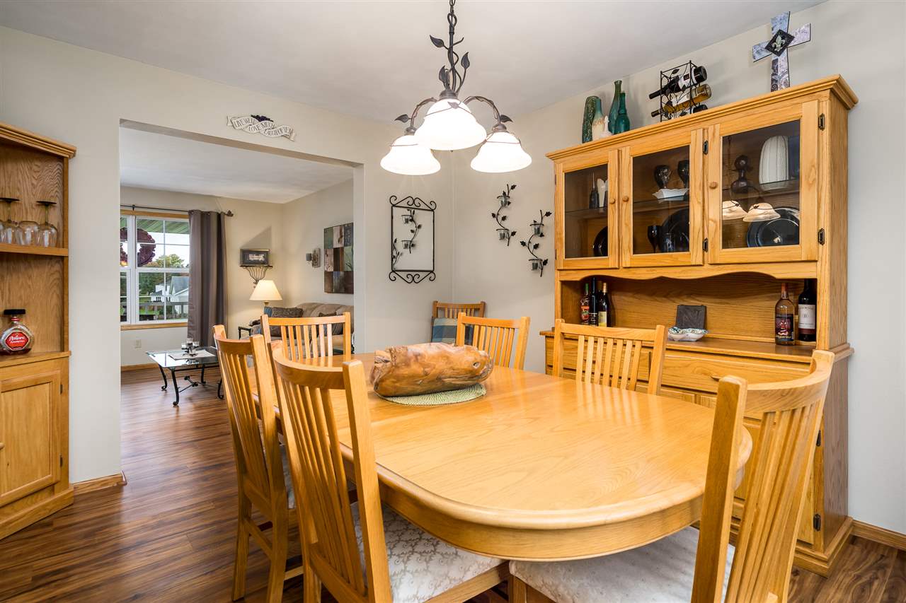 9414 Rambouillet Ridge Roscoe, IL 61073 - Photo 18 of 39 a view of a dining room with furniture and wooden floor
