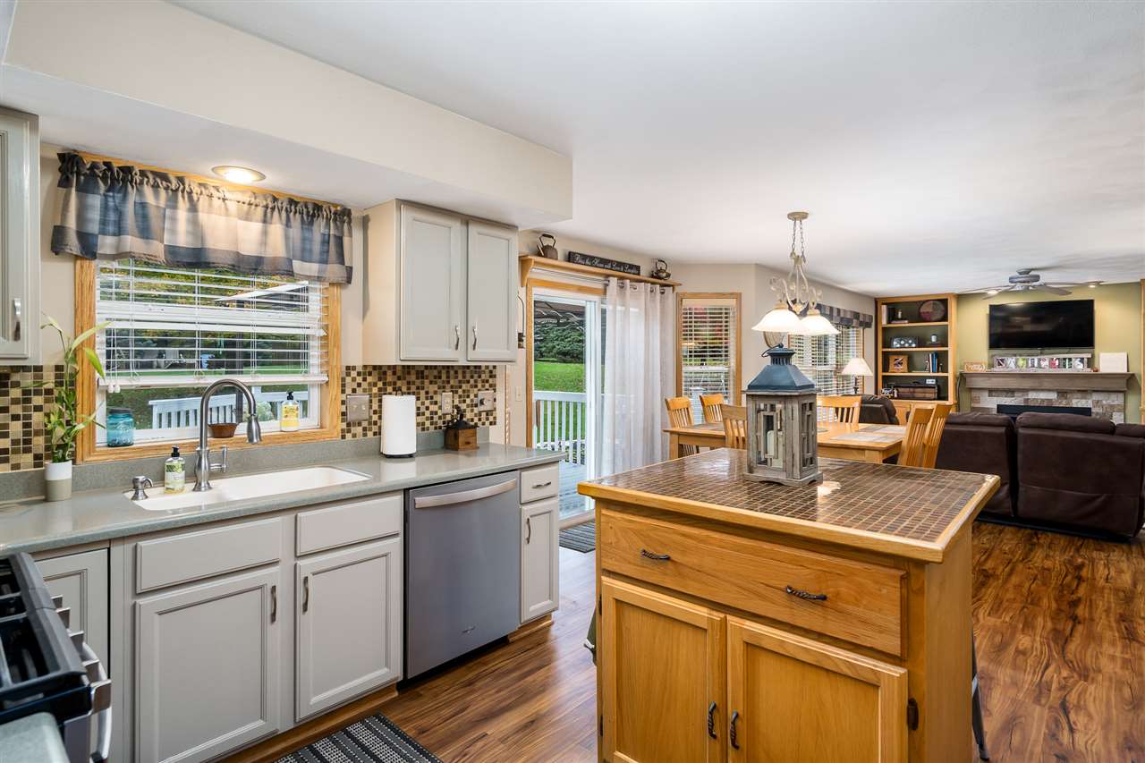 9414 Rambouillet Ridge Roscoe, IL 61073 - Photo 19 of 39 a kitchen with stainless steel appliances granite countertop a sink stove and cabinets